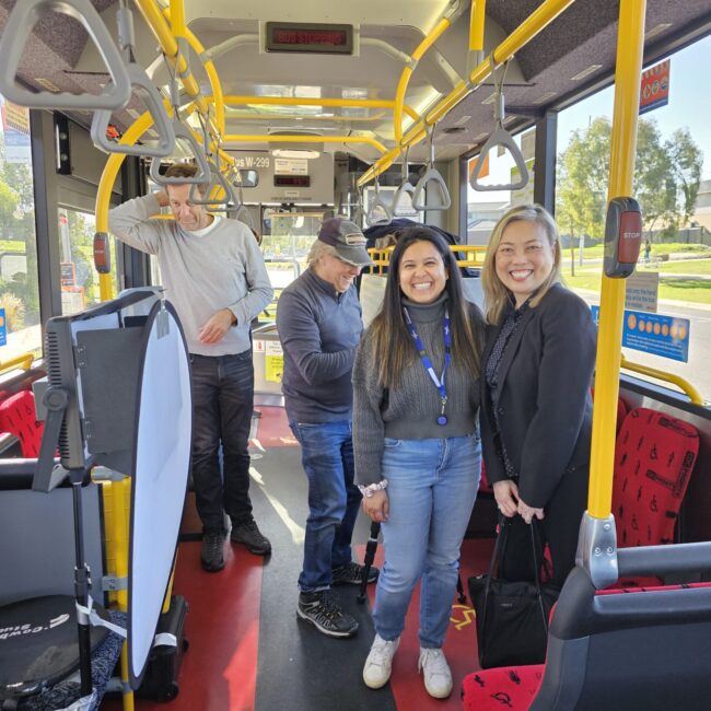 CDC Employees and Community partners smiling on CDC Victoria bus