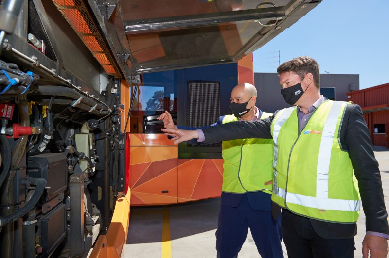 Two people checking CDC Victoria’s zero-emissions hybrid bus